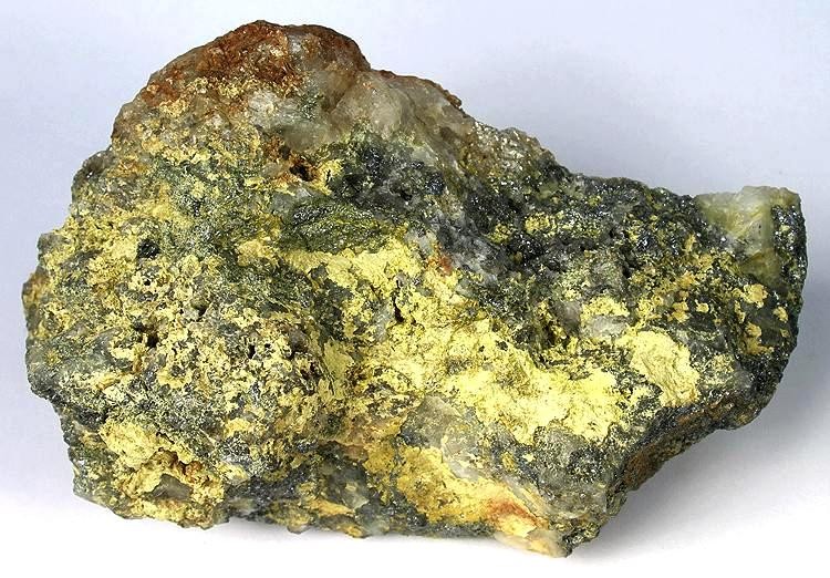 Figure 5: Canary-yellow secondary oxidation crust of molybdite/ferrimolybdite coating primary metallic Molybdenite mineral from the Questa porphyry molybdenum deposit, New Mexico.